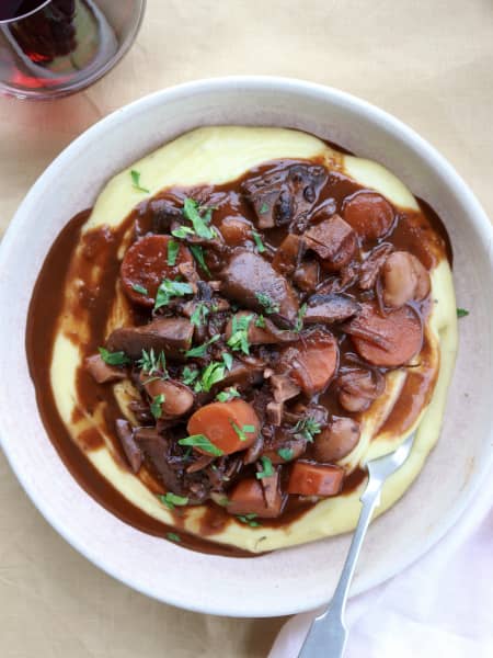 A dish of Vegetarian Bourgignon with garlic mash