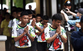 Some of the twelve Thai boys, rescued from a flooded cave after being trapped, arrive to attend a press conference in Chiang Rai on July 18, 2018, following their discharge from the hospital.