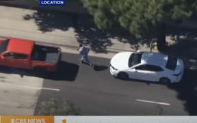 This screenshot from KCAL News / CBS News of one of three men fleeing the scene after a woman was run over and killed in Newport Beach, California.