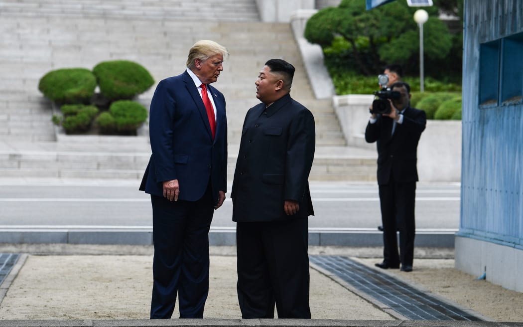 North Korea's leader Kim Jong Un talks with US President Donald Trump as they stand north of the Military Demarcation Line that divides North and South Korea, in the Joint Security Area (JSA) of Panmunjom in the Demilitarized zone (DMZ) on June 30, 2019.