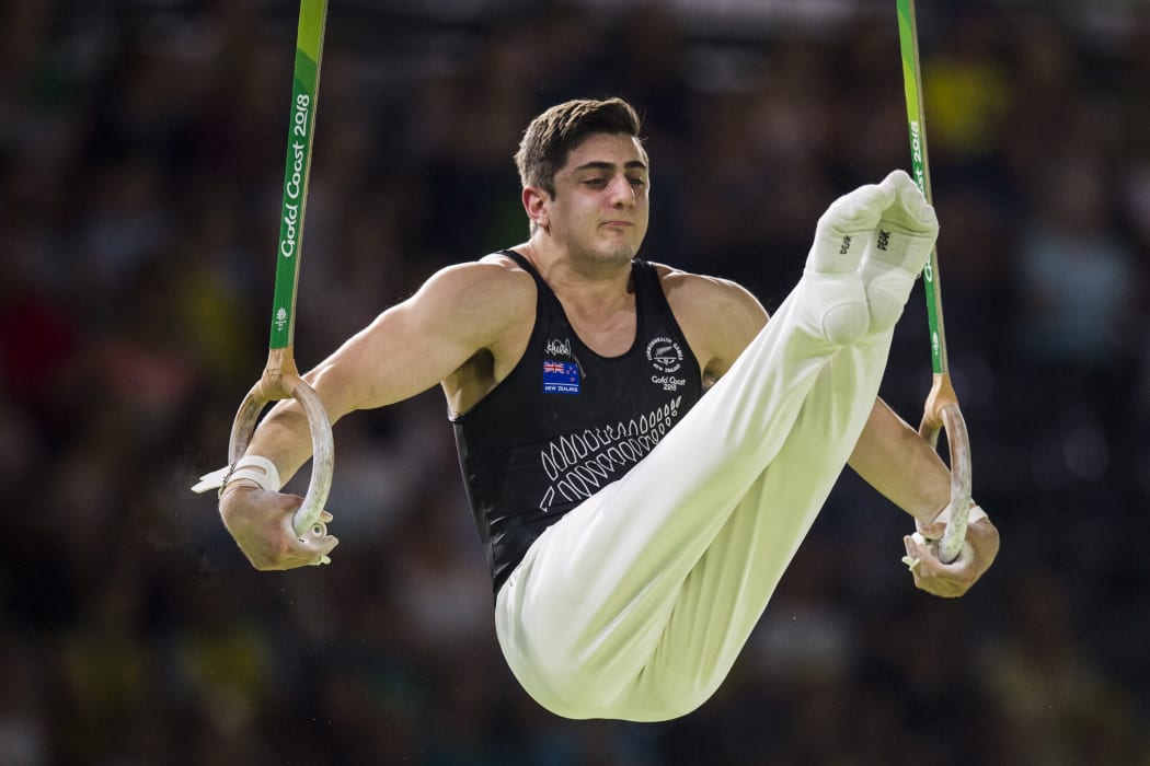 Devy Dyson of New Zeland competes on the rings during the men's team final and individual qualification in the artistic gymnastics event during the 2018 Gold Coast Commonwealth Games at the Coomera Indoor Sports Centre on April 5, 2018. / AFP PHOTO / YE AUNG THU