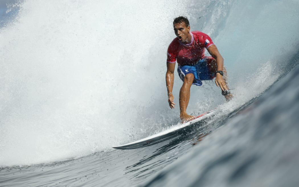 France's Kauli Vaast exits the barrel in the men's surfing gold medal final.
