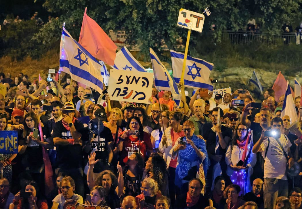 Israeli demonstrators rally in support of a new coalition government in front of the Knesset during a parliamentary vote, in Jerusalem on 13 June, 2021.