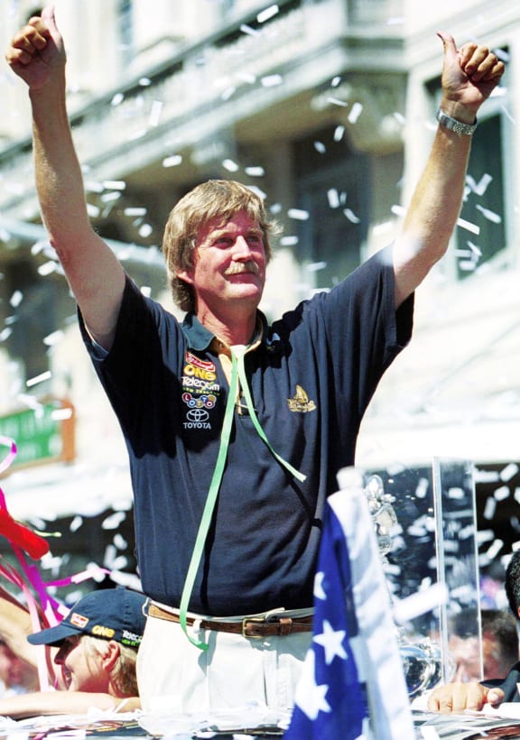 Sir Peter Blake gives the thumbs up during the ticker tape parade in Auckland.