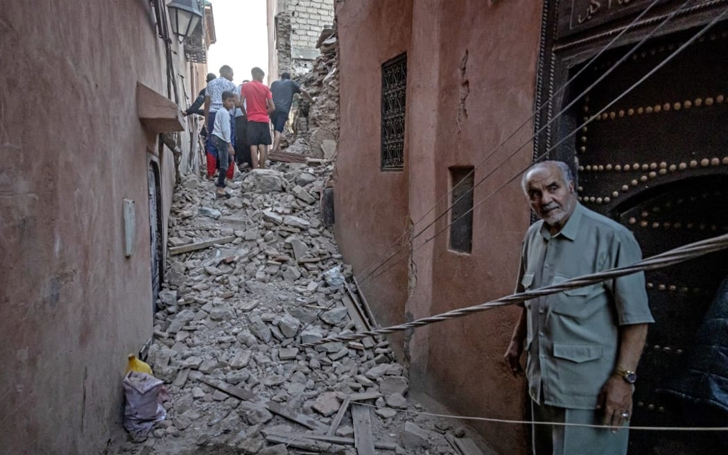 Residents navigate through the rubble in the earthquake-damaged old city of Marrakesh on September 9, 2023.