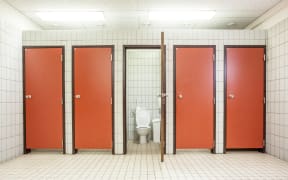 In an public building are womans toilets whit red doors