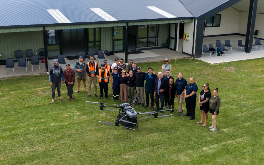 The drone used in the trial and members of the team involved.