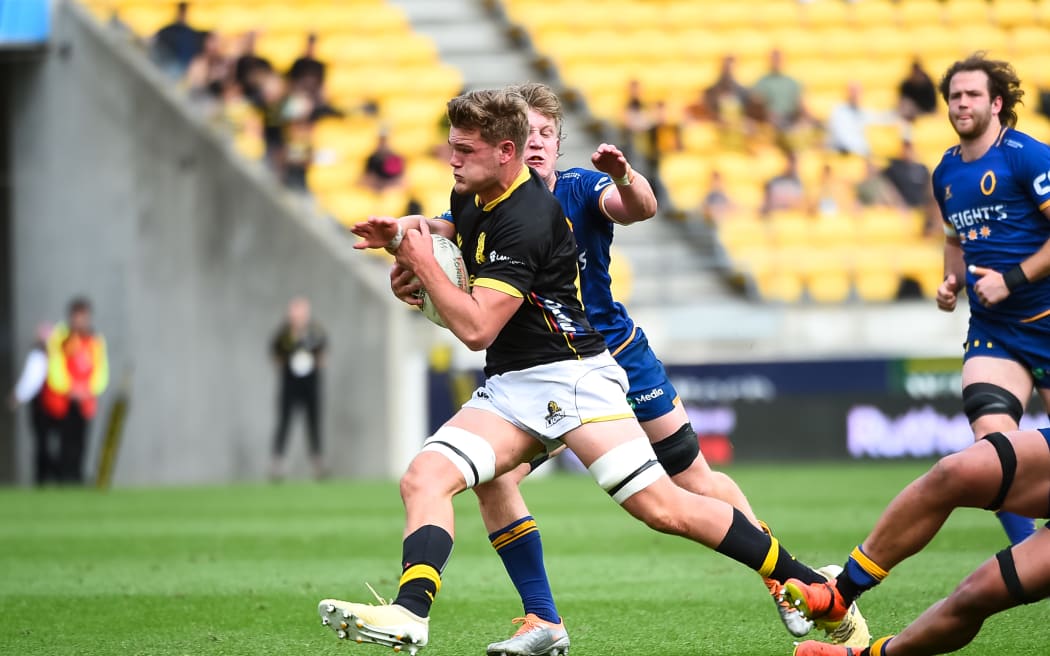 Taine Plumtree of Wellington makes a run.