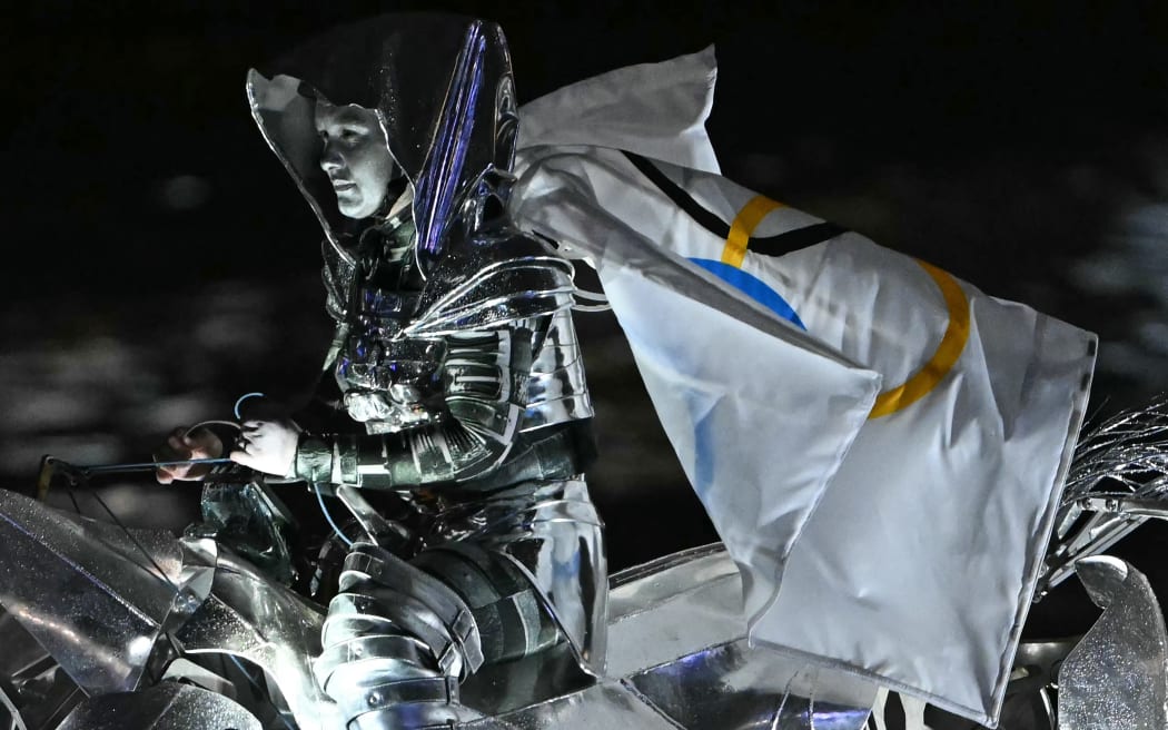 Floriane Issert, a Gendarmerie non-commissioned officer of the National Gendarmerie, rides on a metal horse up the Seine river, during the opening ceremony of the Paris 2024 Olympic Games in Paris on July 26, 2024. (Photo by Mauro PIMENTEL / AFP)
