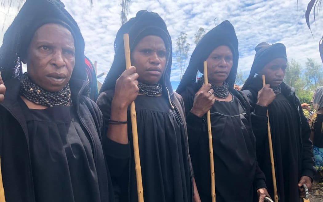 Highlands women attend a funeral for a victim of a sorcery accusation-related attack