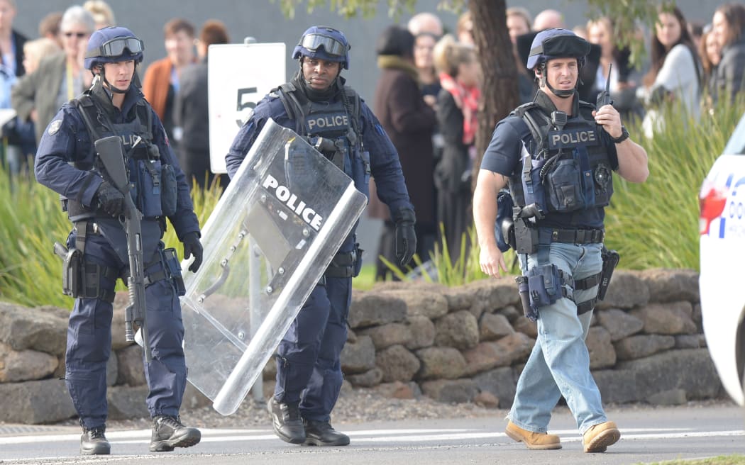 Police outside Melbourne's Ravenhall Prison where masked prisoners were rioting.