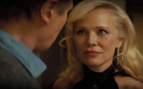 Liam Neeson plays Frank Drebin Jr. and Pamela Anderson plays Beth Davenport in The Naked Gun from Paramount Pictures.
