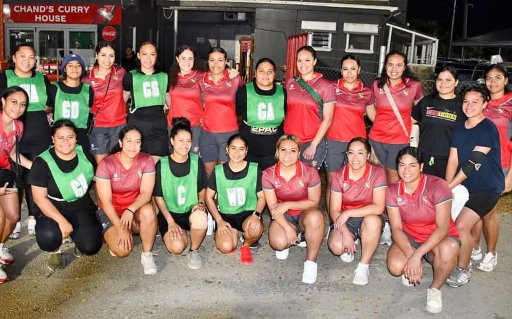Tala coach Jaqua Pori-Makea Simpson (standing left) and members of the team, with local netball players in Tonga earlier this month. Photo: Tonga Netball