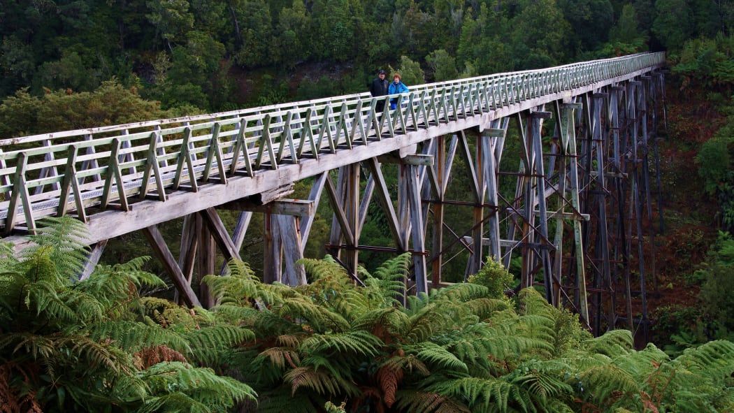 A pair of walkers cross the Percy Burn Viaduct on the South Coast Track near Tuatapere.