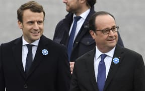 Outgoing French President Francois Hollande (R) and French president-elect Emmanuel Macron arrive to attend a ceremony marking the 72nd anniversary of the victory over Nazi Germany during World War II.