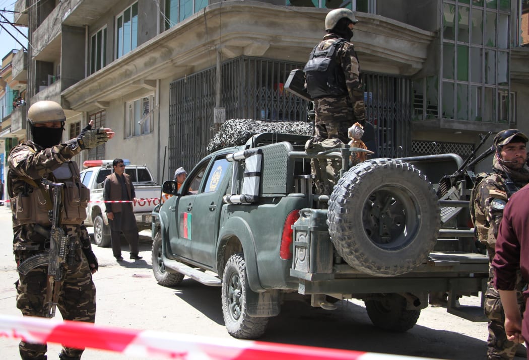 Afghan police officers inspect the scene of a suicide bomb attack that targeted a voter registration center in Kabul, Afghanistan on April 22, 2018.