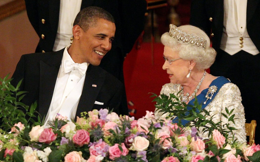 Former US President Barack Obama speaks with Britain's Queen Elizabeth II at Buckingham Palace, in London