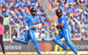 India's Virat Kohli (L) and captain Rohit Sharma cross for a run during the ICC Cricket World Cup 2023 Finals match between India and Australia at the Sardar Vallabhbhai Patel Sports Enclave, Gujarat Cricket Association Stadium in Ahmedabad, Gujarat, India. Sunday, 19 November 2023.