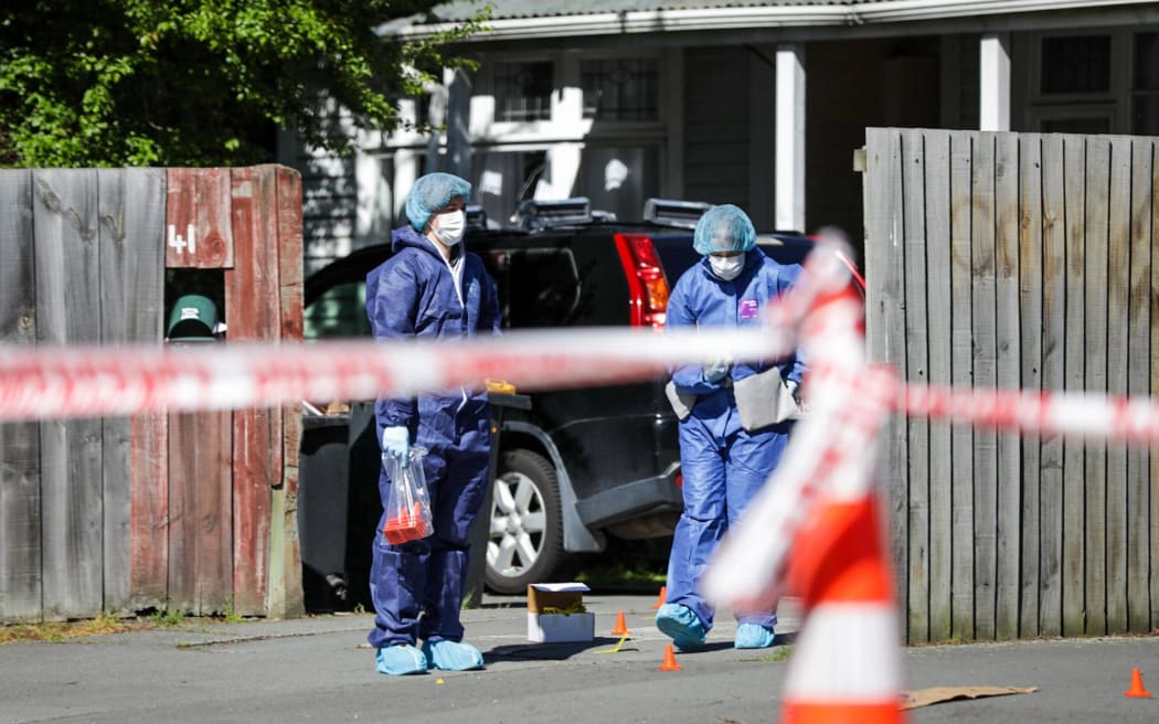 Police examine the scene in Riccarton, Christchurch where a person died overnight.