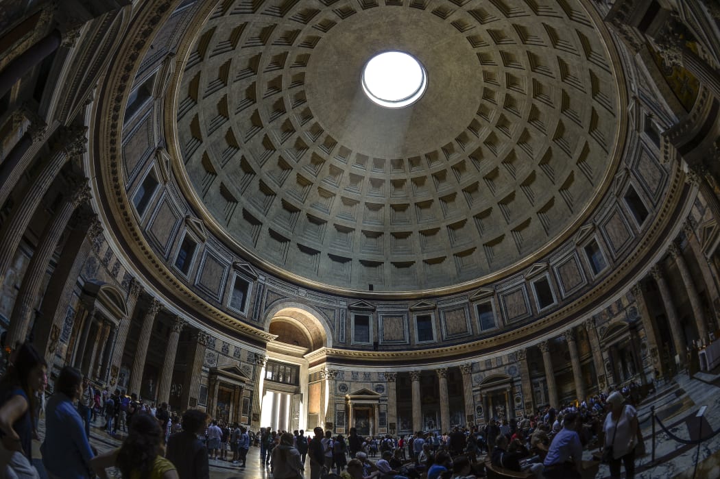 A ray of sunlight illuminates the central door of the Pantheon through the dome in April 2015.