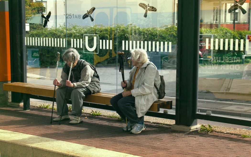 rasstat, Germany - September 13, 2017: Maintaining health for elderly. Heel-and-toe walk. Women with ski poles stop. On glasses stop caused silhouettes of birds of prey to broken birds and people