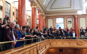 Whanganui iwi sing waiata after the passing of the third and final reading of te Awa Tupua, (Whanganui River Claims Settlement), Bill.