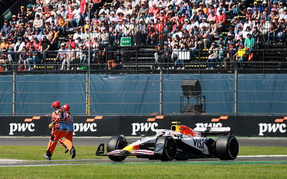 MEXICO CITY, MEXICO - OCTOBER 26: Liam Lawson of New Zealand driving the (30) Visa Cash App Racing Bulls VCARB 02 as marshals run on track during the F1 Grand Prix of Mexico at Autodromo Hermanos Rodriguez on October 26, 2025 in Mexico City, Mexico. (Photo by Hector Vivas/Getty Images)