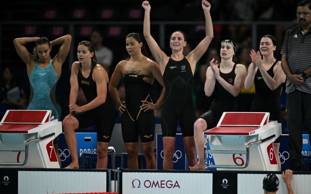 Team New Zealand (R)  react after a heat of the women's 4x200m freestyle relay swimming event during the Paris 2024 Olympic Games at the Paris La Defense Arena in Nanterre, west of Paris, on August 1, 2024. (Photo by Oli SCARFF / AFP)