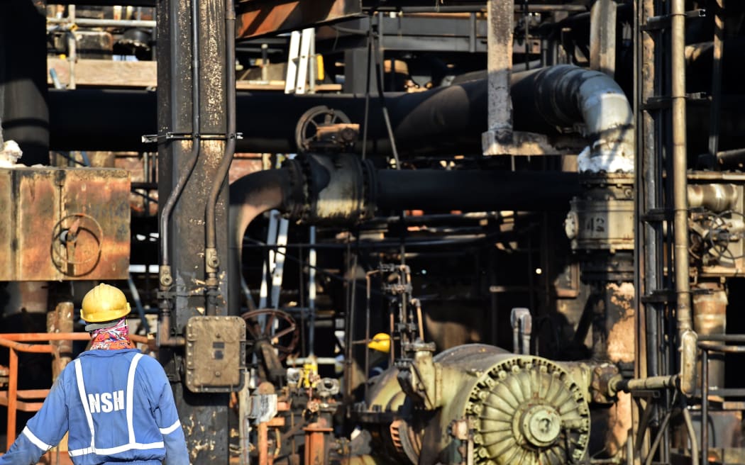 An employee of Aramco oil company looks at a destroyed installation in Saudi Arabia's Abqaiq oil processing plant on September 20, 2019.