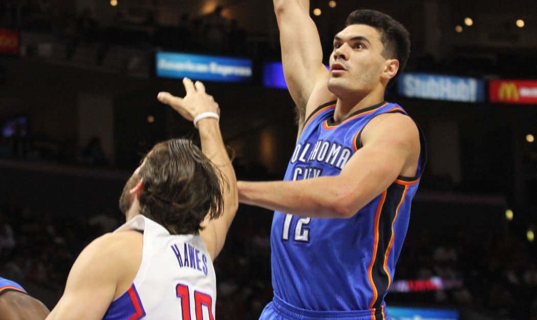 New Zealand basketball player Steven Adams with a one-handed hook shot.