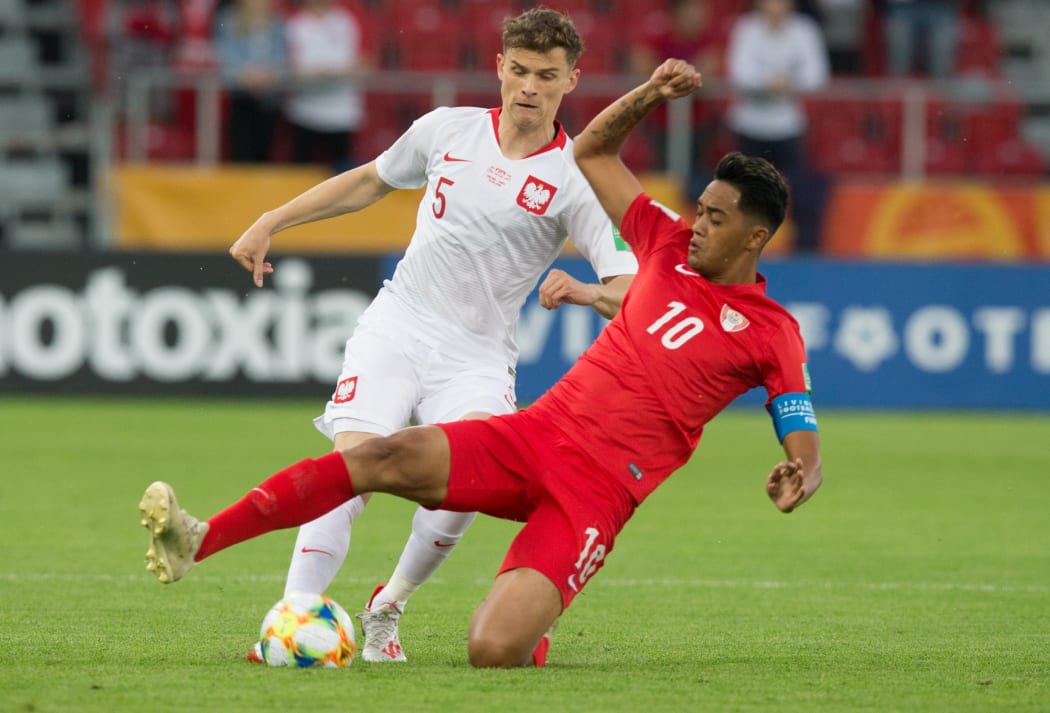 Tahiti's Roonui Tehau battles for possession with Poland's Serafin Szota during their FIFA U-20 World Cup group A match.