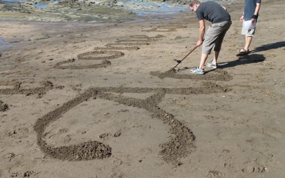 In the foreground is an italicised capital "A" while in the background Peter continues to work.