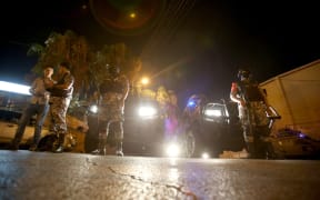Security forces stand guard outside the Israeli embassy in the residential Rabiyeh neighbourhood of the Jordanian capital Amman.