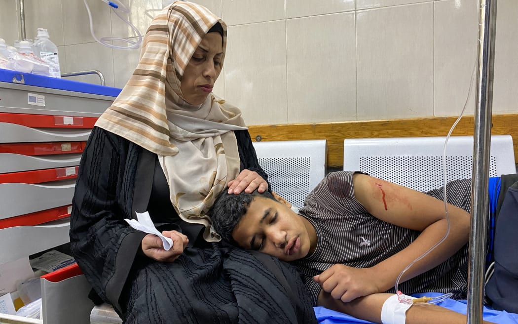 A Palestinian youth who was injured by Israeli fire near a US-backed aid center in the Rafah area, receives treatment at the Nasser hospital in the southern Gaza Strip on 3 June 2025.