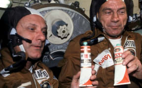 NASA astronauts enjoying fake “vodka” – Russian vodka labels pasted on top of  borscht tubes. Public domain. (not quite beer)