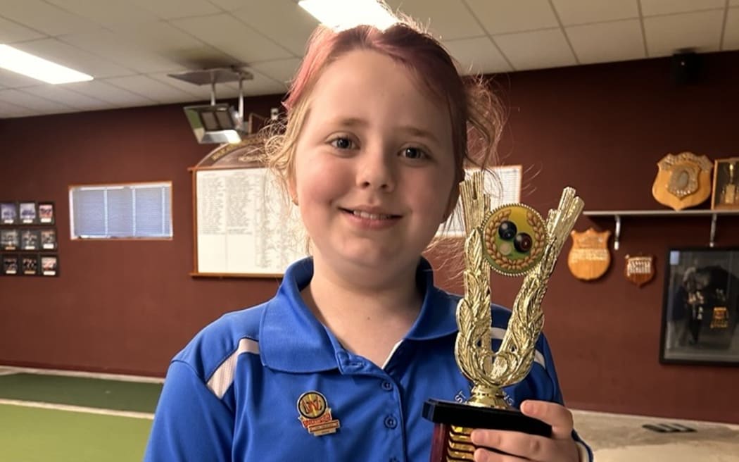 Pixie Blake, 9, holding the Champion of Champions trophy.