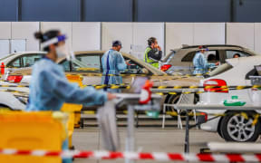 Residents in their cars queue at a drive-through Covid-19 testing facility at the Melbourne Showgrounds on 16 July, 2021.