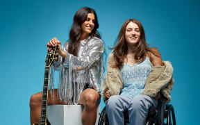 Sophia and Indy with a guitar