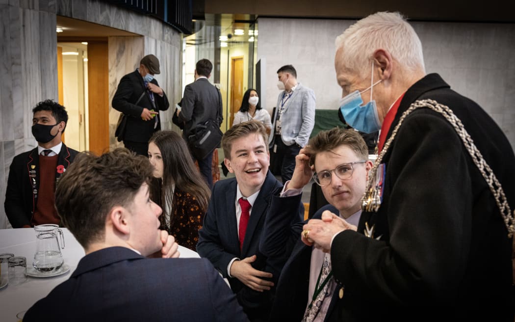 After the opening ceremony the Herald of Arms Extraordinary to the Queen, Phillip O'Shea chats with Youth MPs William Bell-Purchas and Keelan Heesterman.