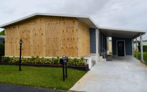 A boarded up house is seen in Deerfield Beach, Florida on September 2, 2019. -