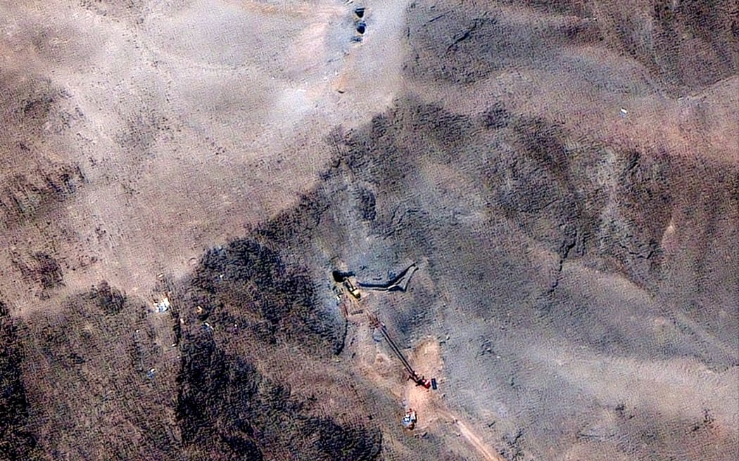 A satellite image provided by Maxar Technologies and dated 29 June 2025 shows a close view of activity at the ventilation shaft at the Fordow Fuel Enrichment Plant complex.