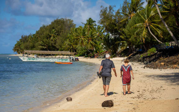 Tourists on Muri Beach, Rarotonga, Cook Islands.