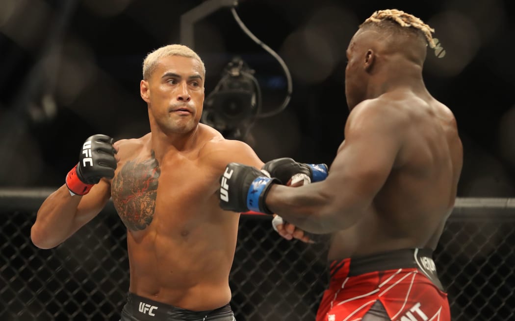 Carlos Ulberg (L) throws a punch at Fabio Cherant (R) enroute to a unanimous decision victory at UFC 271 in Houston, Texas.