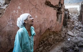 A woman stands in front of her earthquake-damaged house in the old city in Marrakesh on September 9, 2023.