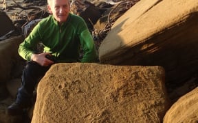 Geoscience communicator Julian Thomson with some of the moa footprints he and Dr Bruce Hayward discovered at Kaipara's South Head.