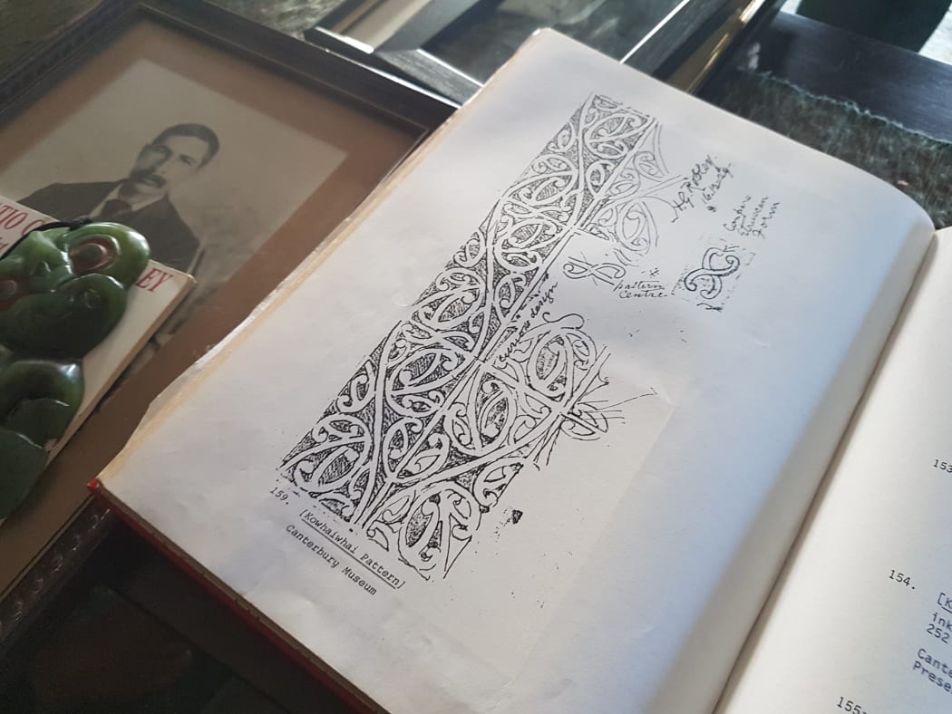 Googie Tapsell's coffee table. An image of Robley's son Hamiora Tu is top left, a  tiki once owned by Robley is bottom left, center is a page from Robley's book on moko