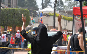 A woman outside Enrique Rébsamen school in Mexico City where at least 21 children died.