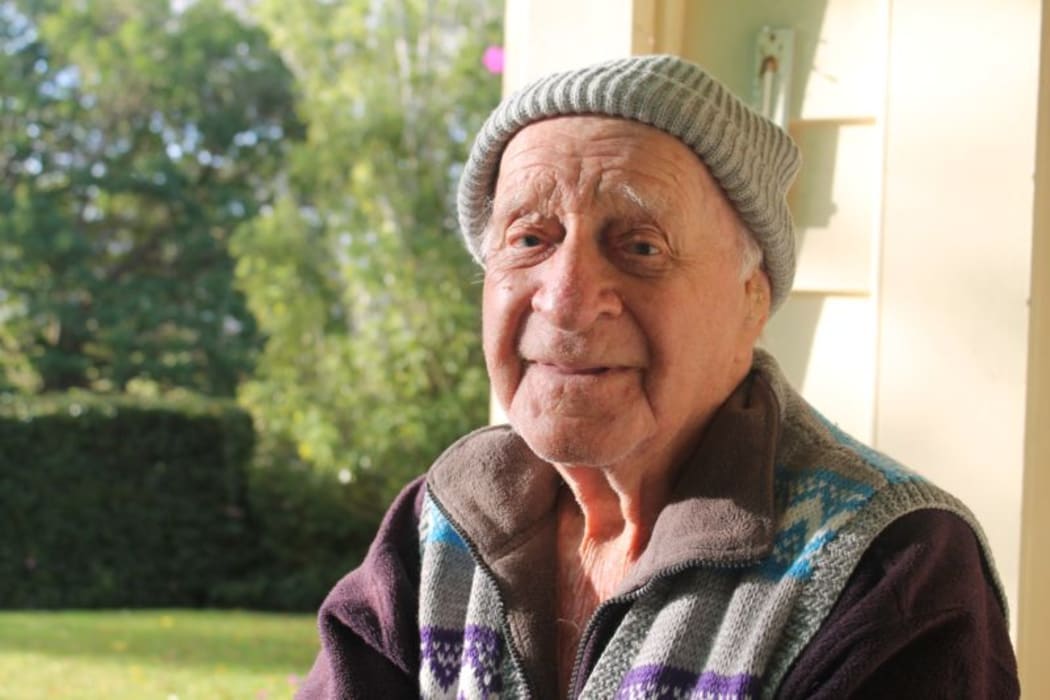 This is an image of Bill Tuckey sitting in the sun on his porch
