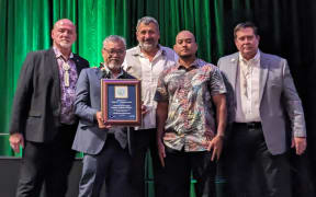 Marshall Islands Marine Resources Authority director Glen Joseph (holding award), MIMRA Oceanic Division Chief Fisheries Officer Mr Beau Bigler (floral shirt), and MIMRA/NZMFAT Fisheries Advisor, Mr Francisco Blaha (centre), receiving the award from the International Fisheries Monitoring, Control and Surveillance Network officials.