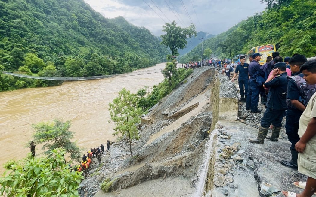 Rescuers search for survivors in river Trishuli in Simaltar on July 12, 2024, at the site of a landslide. At least 63 people were missing in Nepal on July 12 after a landslide triggered by heavy monsoon rains swept two buses off a highway and into a river, authorities said. (Photo by RAJESH GHIMIRE / AFP)